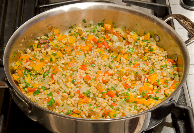 The vegetables are added back into the couscous.