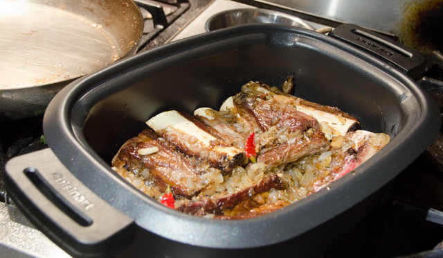 Nestling the browned short ribs into the sauce.