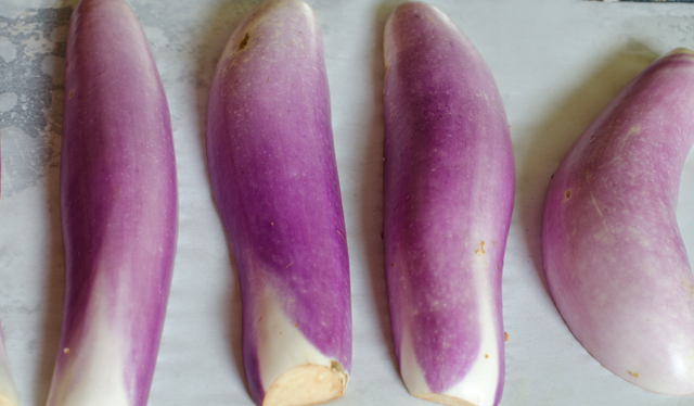 Place the eggplants cut side down on a parchment lined baking sheet.