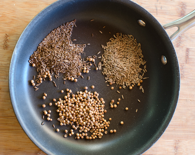 Cumin, coriander and caraway seeds are toasted in a dry pan.
